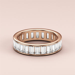 Elegant 14K Rose Gold wedding band featuring emerald channel-set baguette diamonds in a stunning eternity design. 