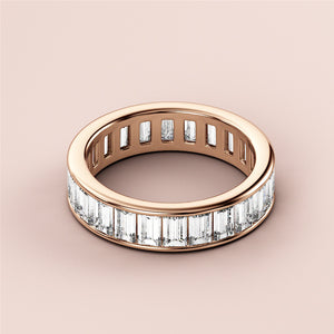 Stunning 14K/18K rose gold emerald channel eternity wedding band with exquisite craftsmanship and luxurious design. 