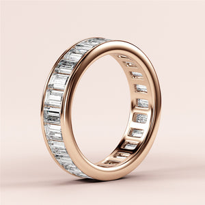 Elegant 14K or 18K rose gold wedding band featuring baguette-cut diamonds in channel setting for ultimate eternity style. 