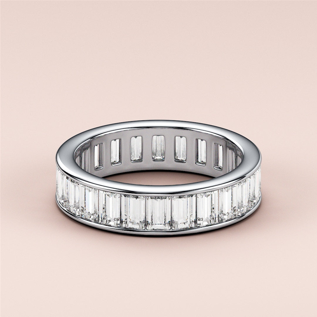 Elegant emerald channel eternity ring in 14K or 18K white gold, featuring baguette-cut diamonds, perfect for weddings. |
 #14KRecycledWhiteGold
 #18KRecycledWhiteGold
 
 
 
 
 #Platinum