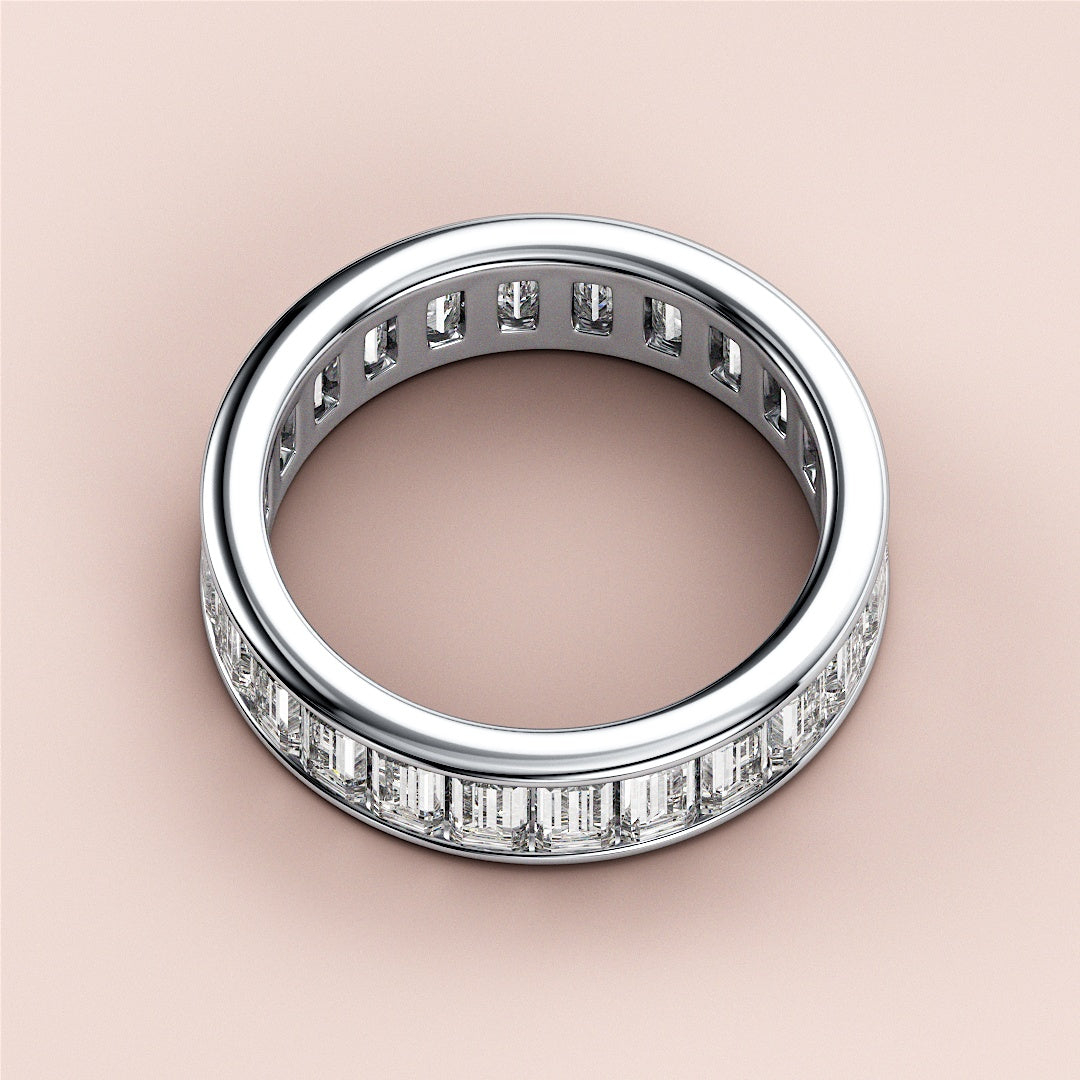Elegant 14K/18K white gold wedding band featuring emerald channel eternity design with rectangular diamond baguettes. |
 #14KRecycledWhiteGold
 #18KRecycledWhiteGold
 
 
 
 
 #Platinum