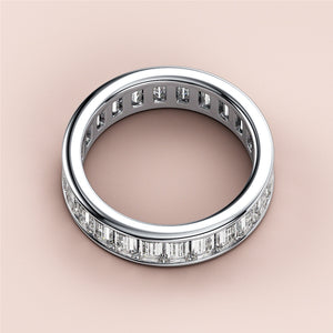 Elegant 14K/18K white gold wedding band featuring emerald channel eternity design with rectangular diamond baguettes. 
