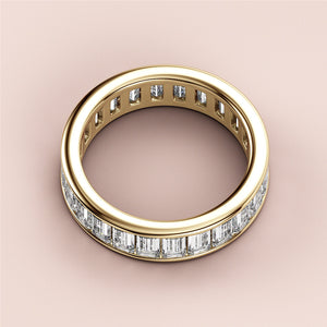 Elegant 14K yellow gold emerald channel eternity wedding band featuring diamond baguettes for timeless sophistication. 