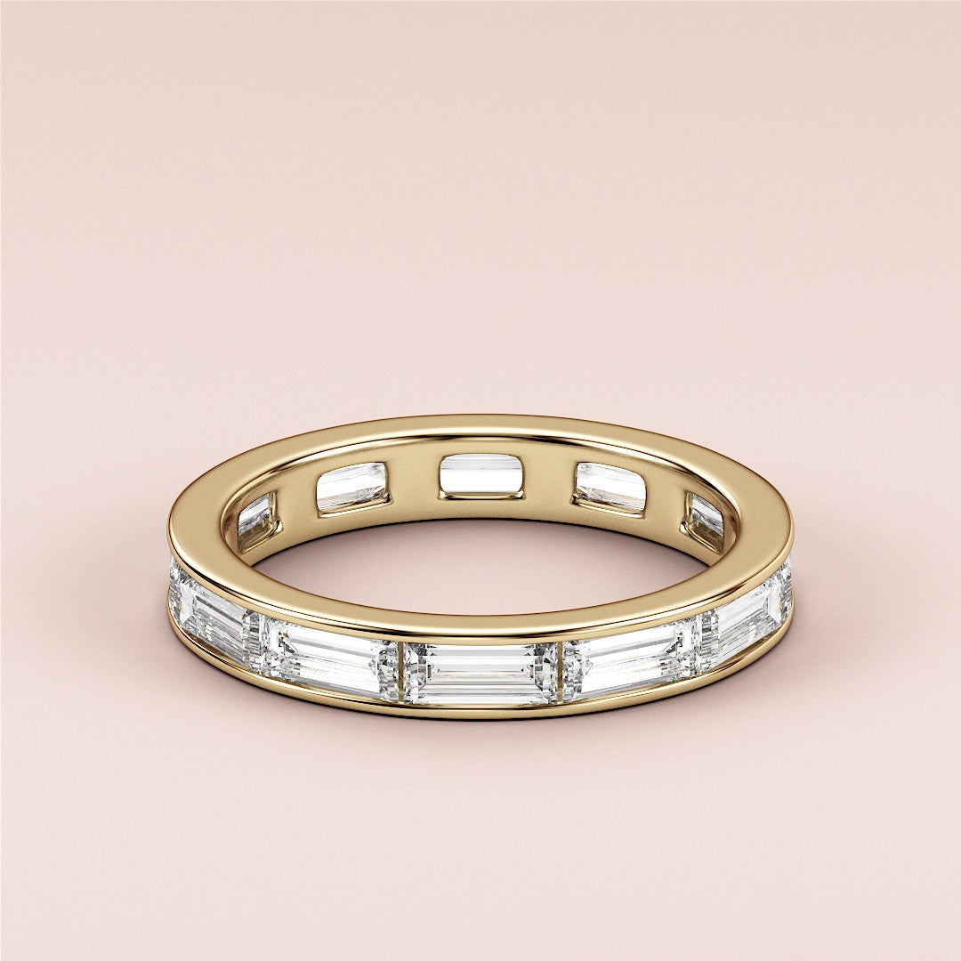 Elegant women's wedding band featuring baguette-cut diamonds in a yellow gold band, available in 14K, 18K, or platinum. |
 
 
 #14KRecycledYellowGold
 #18KRecycledYellowGold