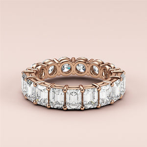 Luxurious rose gold (14K/18K) eternity band with emerald-cut diamonds, a timeless wedding band exuding elegance and sophistication. 