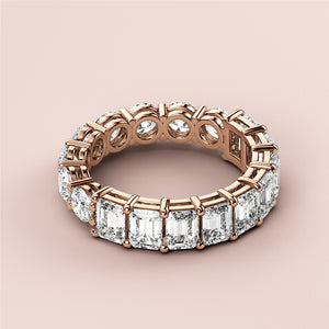 Elegant 18K rose gold half-round emerald eternity wedding band with dazzling diamonds, perfect for celebrating love. 