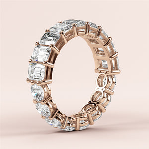 Elegant 14K or 18K rose gold eternity ring with emerald-cut diamonds, perfect for weddings and special occasions. 