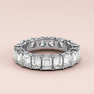 Elegant 14K white gold eternity band featuring emerald-cut and round diamonds, perfect for weddings and special occasions. 
