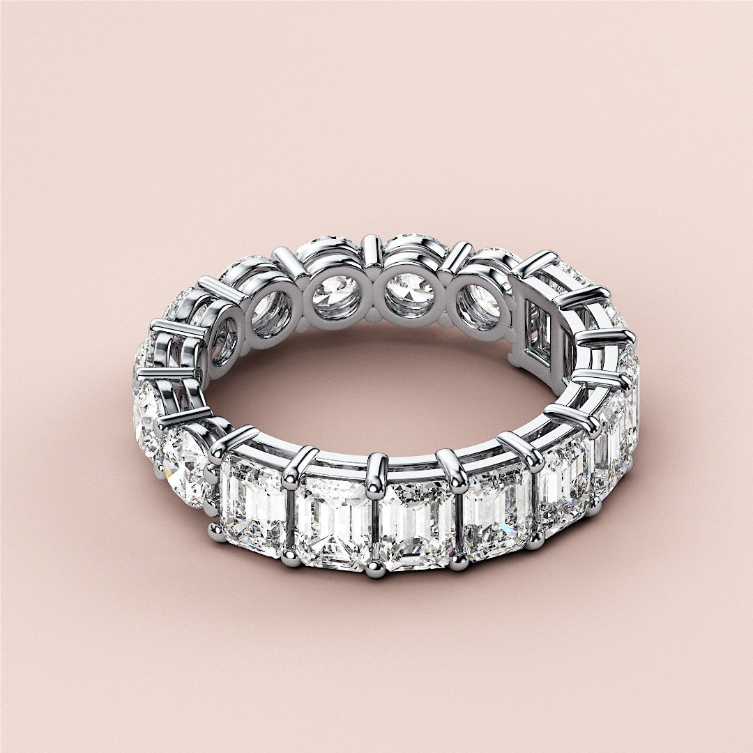 Elegant 14K or 18K white gold eternity band with radiant cut diamonds in a prong setting, perfect for weddings. 