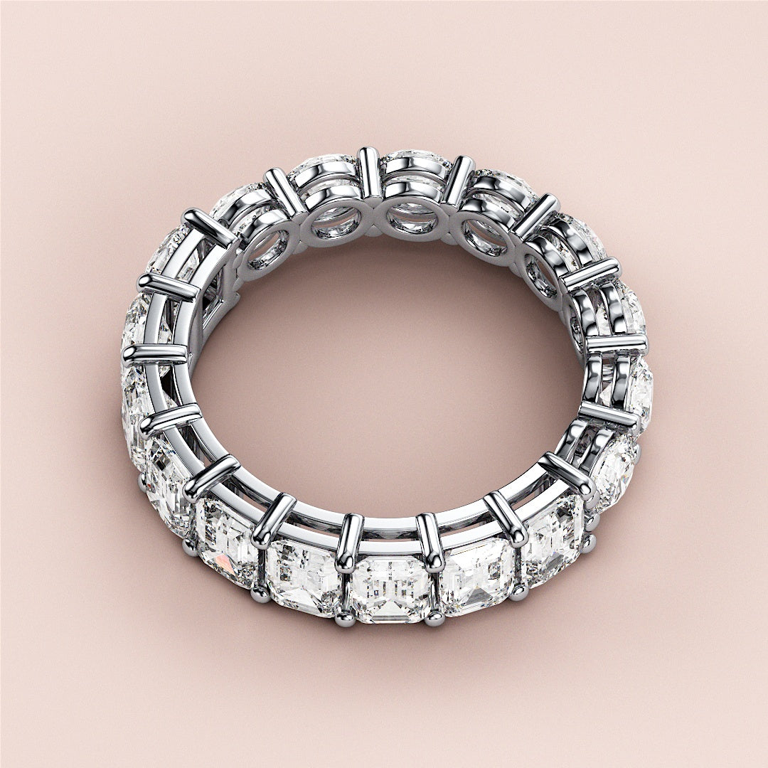 Elegant 14K white gold eternity band ring with emerald-cut diamonds, perfect for weddings and special occasions. 