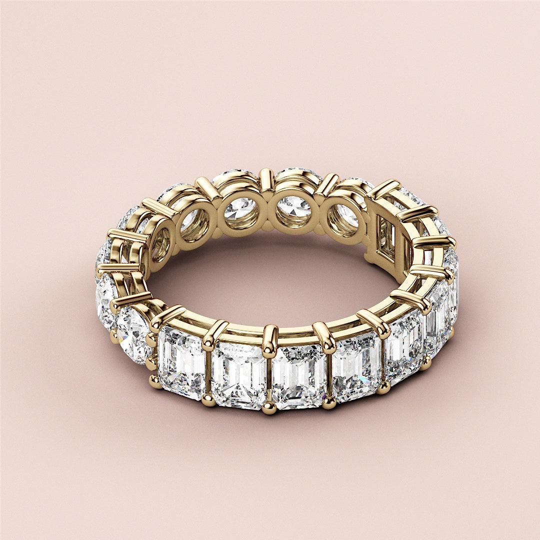 Stunning 14K yellow gold wedding band featuring half emerald eternity design, radiating elegance and timeless beauty. 