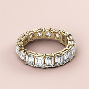 Stunning 14K yellow gold wedding band featuring half emerald eternity design, radiating elegance and timeless beauty. 