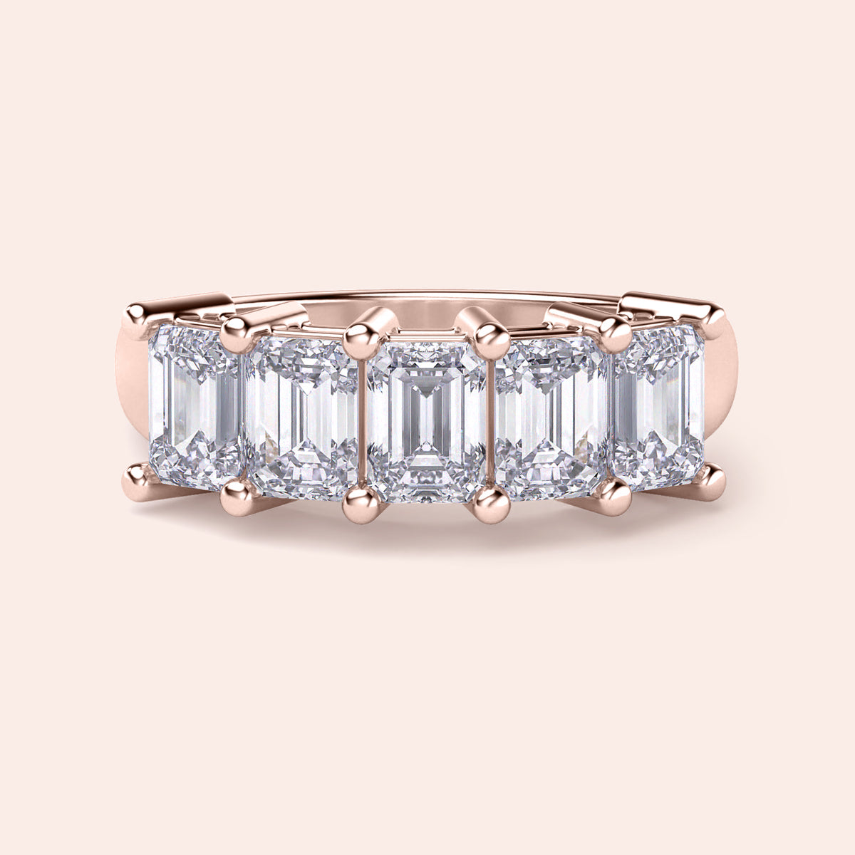 14K or 18K rose gold wedding band featuring a stunning emerald-cut diamond center, perfect for elegant occasions. 