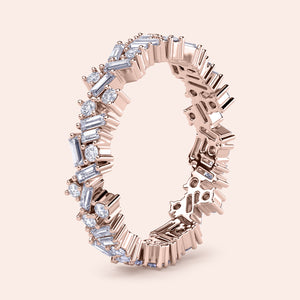 14K rose gold wedding band with an intricate design of sparkling baguette and round diamonds, offering luxurious elegance. 