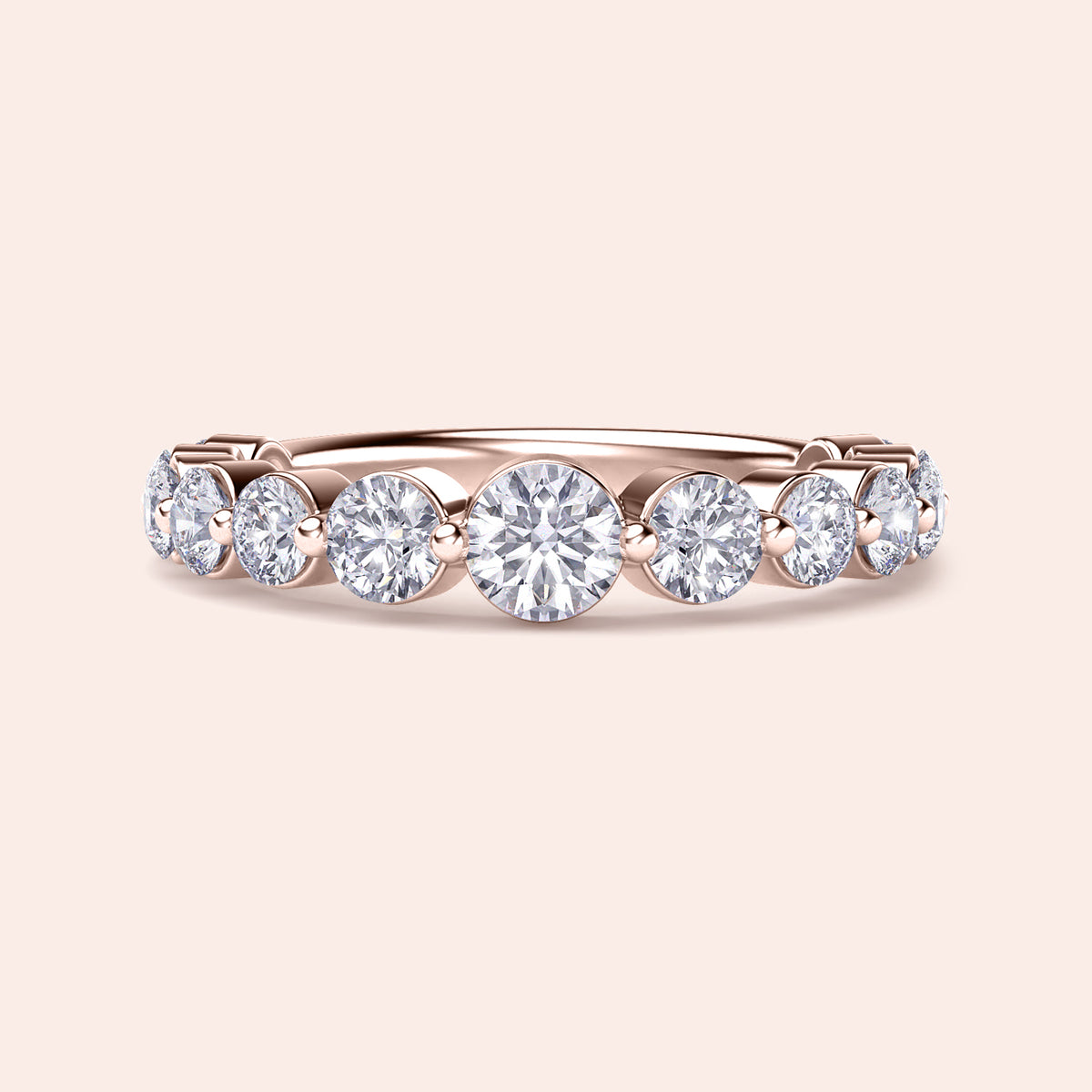 Rose Gold wedding band featuring round brilliant-cut diamonds in a shared prong setting, available in 14K or 18K gold. 