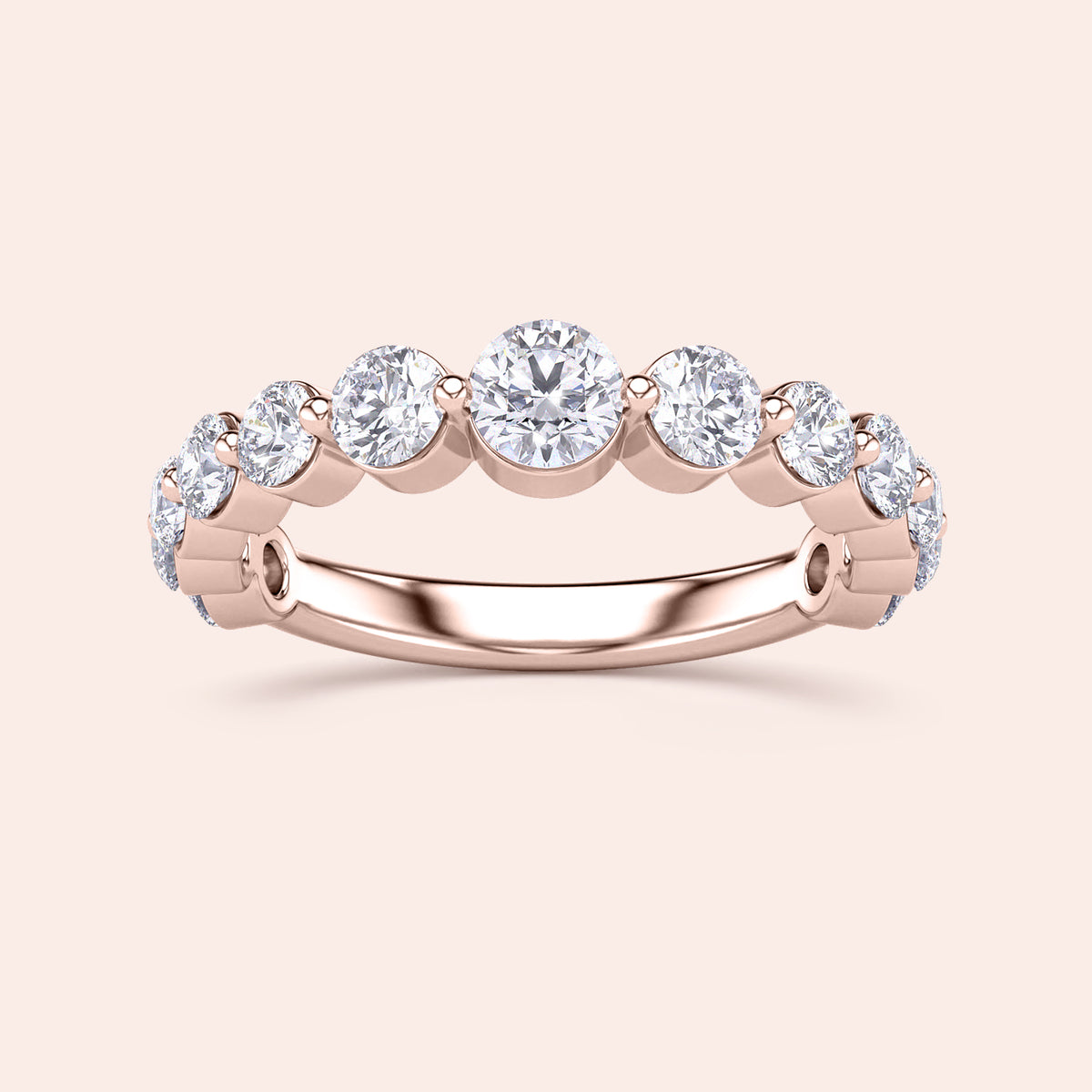 Elegant 14K or 18K rose gold wedding band featuring round brilliant cut diamonds in a shared prong setting. 
