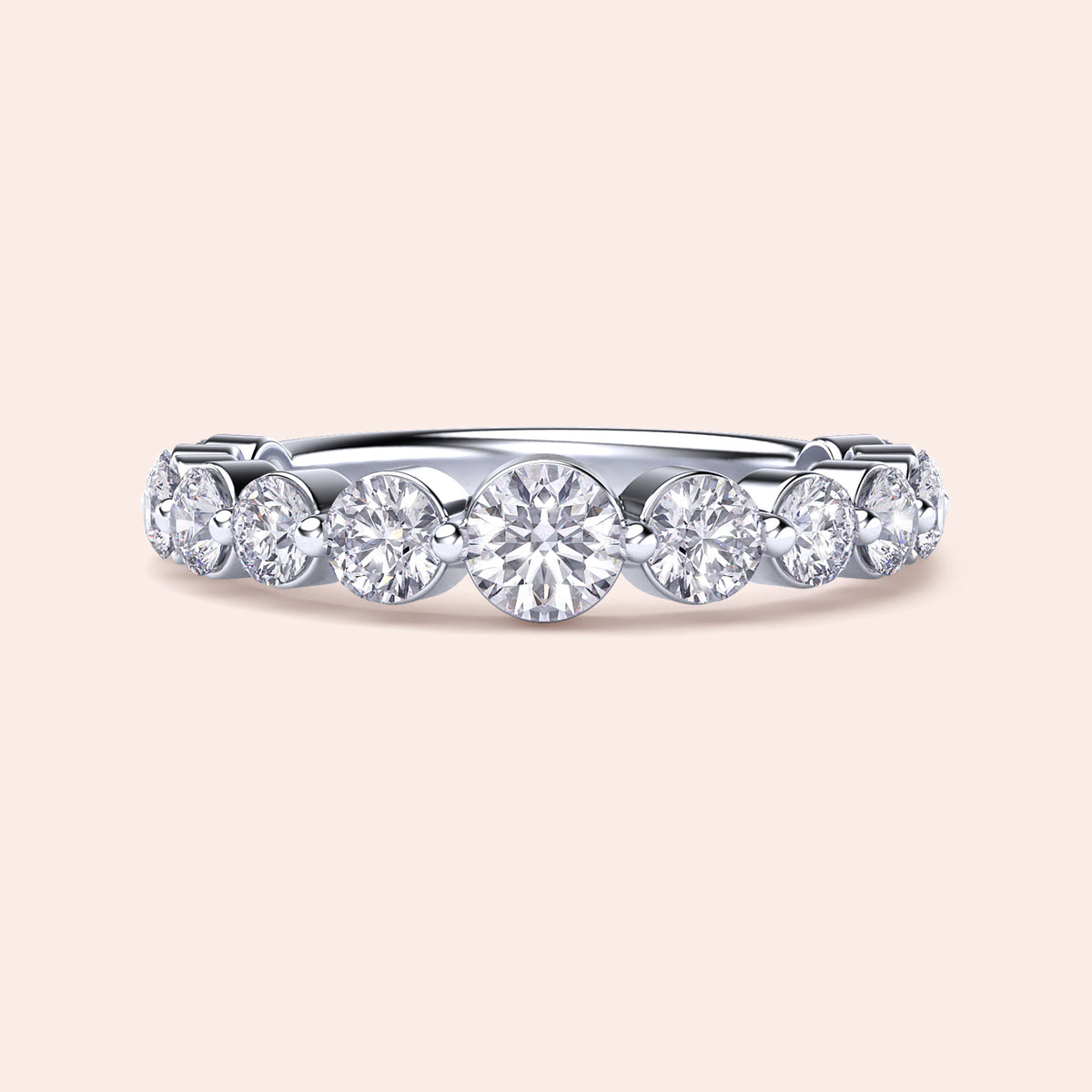 Elegant white gold wedding band featuring shared prong round brilliant cut diamonds, available in 14K or 18K options. 