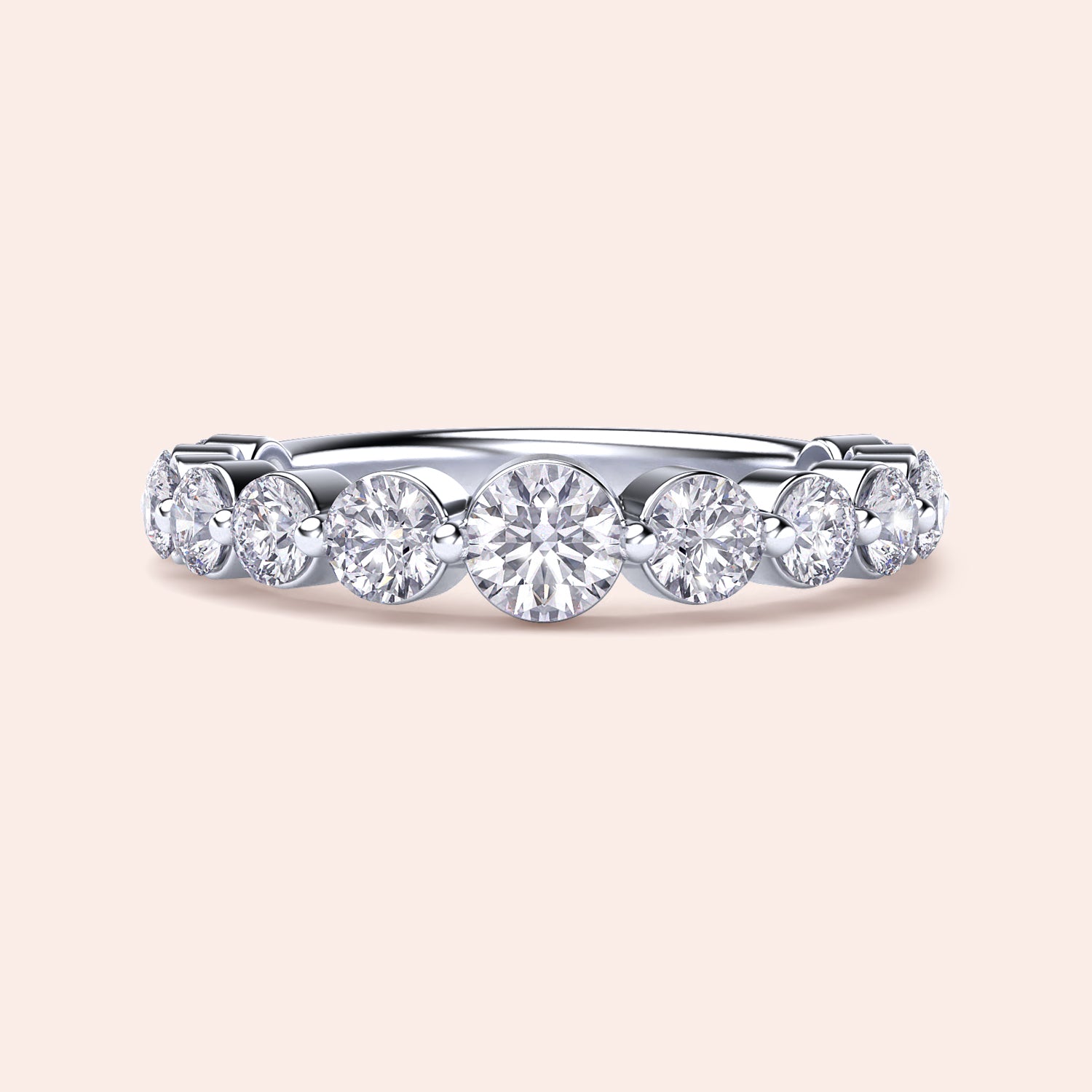 Elegant white gold wedding band featuring shared prong round brilliant cut diamonds, available in 14K or 18K options. 