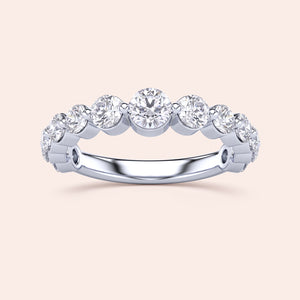 Elegant 14K/18K gold or platinum half eternity wedding band with round brilliant-cut diamonds in a sleek prong setting. 