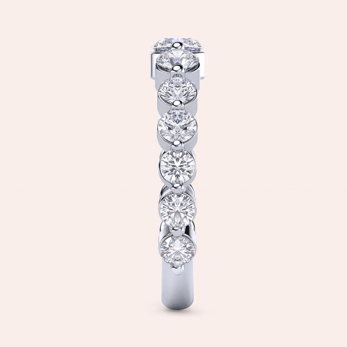 Elegant white gold wedding band featuring a stunning row of round brilliant-cut diamonds in a shared prong setting. 
