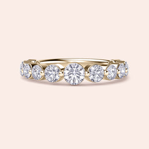 Elegant yellow gold wedding band with shared prong round diamonds, available in 14K, 18K, or platinum for timeless luxury. 