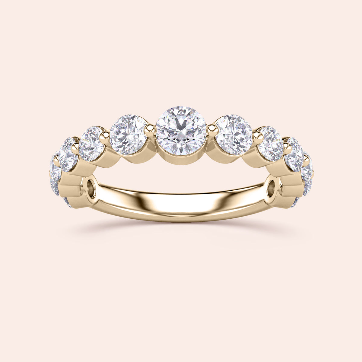 Elegant yellow gold wedding band featuring round brilliant-cut diamonds in a prong setting, available in 14K and 18K. 