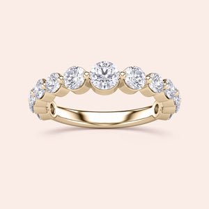 Elegant yellow gold wedding band featuring round brilliant-cut diamonds in a prong setting, available in 14K and 18K. 