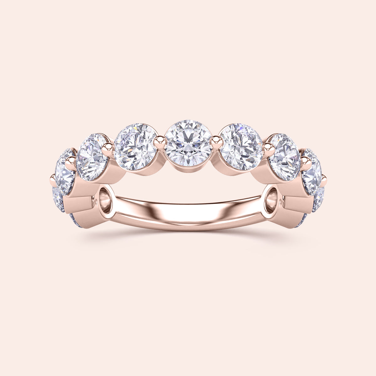 Elegant 14K rose gold wedding band featuring five round brilliant-cut diamonds in bezel settings, perfect for eternal vows. 