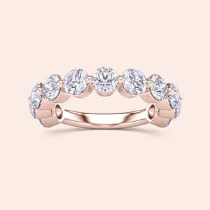 Elegant 14K rose gold wedding band featuring five round brilliant-cut diamonds in bezel settings, perfect for eternal vows. 
