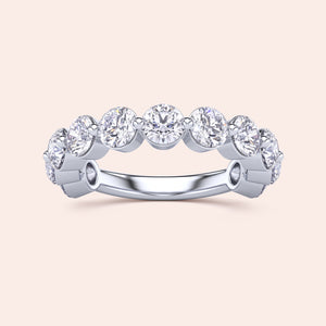 Elegant 14K/18K white gold eternity ring with round brilliant cut diamonds in a bezel setting, perfect as a wedding band. 