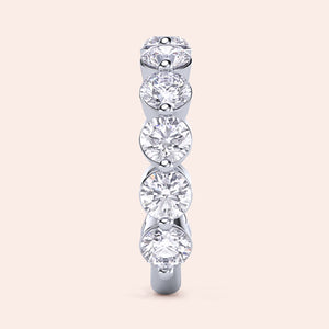 Elegant round diamond eternity band in 14K or 18K gold or platinum, showcasing brilliant round-cut diamonds in prong setting. 