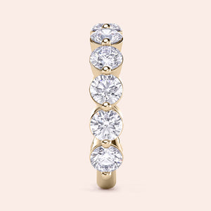 Elegant 14K or 18K gold wedding band with shared prong setting and round diamonds, a timeless piece for eternal love. 