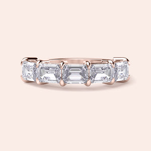 Elegant rose gold wedding band featuring five emerald-cut stones, available in 14K and 18K gold or platinum. 