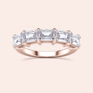 Elegant 14K or 18K rose gold wedding band featuring radiant emerald-cut diamonds in a five-stone design. 