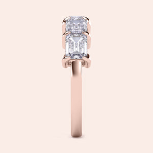 Elegant 14K rose gold wedding band featuring five emerald-cut diamonds in a classic prong setting, perfect for special occasions. 