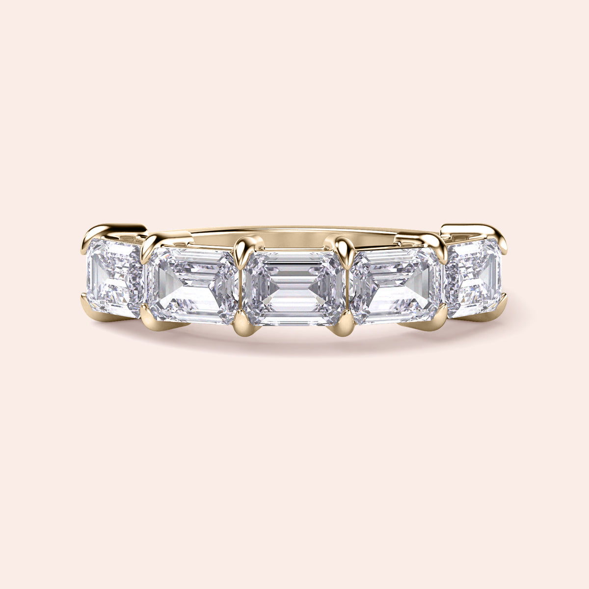 Elegant 14K and 18K gold wedding band featuring three emerald-cut diamonds, exuding timeless sophistication and luxury.