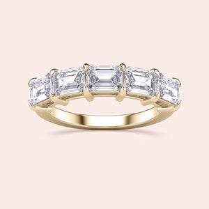 Elegant 14K yellow gold wedding band featuring five emerald-cut diamonds for a luxurious finish. 