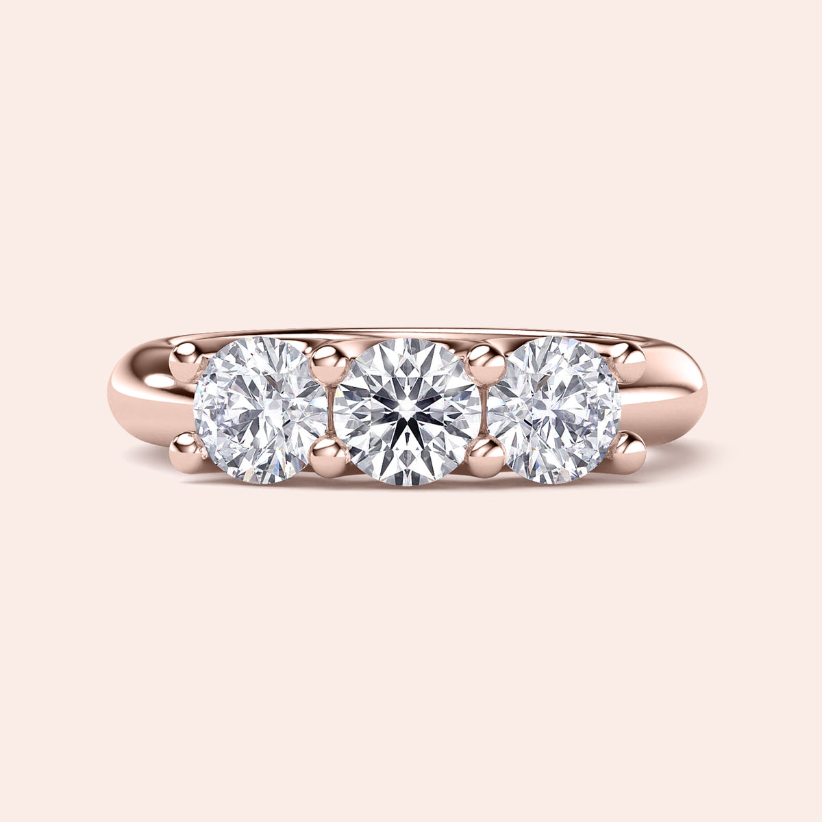 Rose gold three-stone wedding band in 14K/18K or platinum, featuring round brilliant cut diamonds for timeless elegance. 