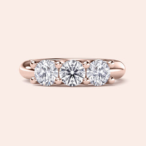 Rose gold three-stone wedding band in 14K/18K or platinum, featuring round brilliant cut diamonds for timeless elegance. 