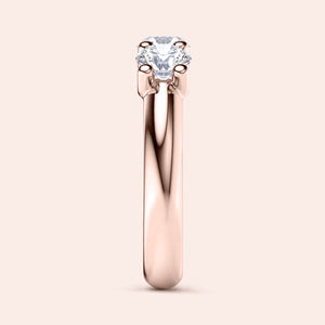 Elegant 14K or 18K rose gold three-stone wedding band with round brilliant diamonds, not worn on a model. 