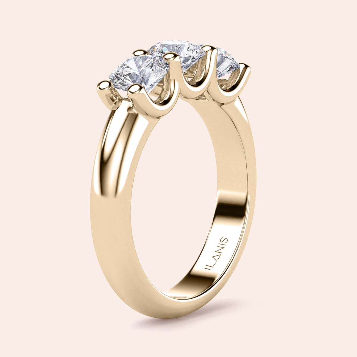 Elegant three-stone wedding band in 14K or 18K gold or platinum, featuring a round cut diamond design. 