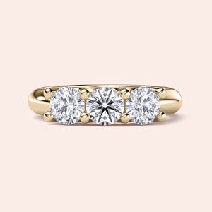 Three-stone engagement ring featuring round diamonds in a yellow gold band, available in 14K, 18K, or platinum wedding band styles. 