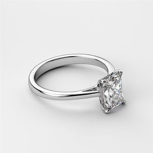 Elegant solitaire engagement ring featuring a radiant cut diamond on a sleek 14K or 18K white gold or platinum band.