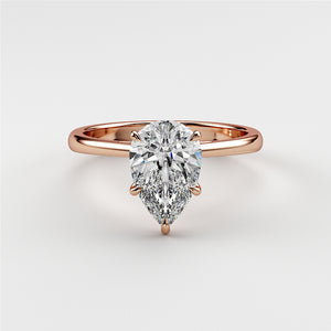 Exquisite rose gold pear-shaped diamond engagement ring, available in 14K, 18K, or platinum setting.