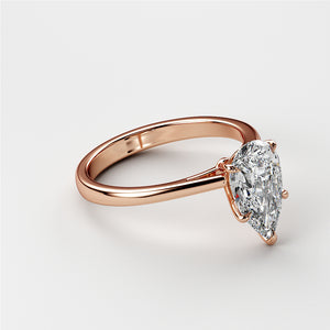 Exquisite pear-shaped diamond engagement ring in sleek 14K rose gold band, perfect for special occasions.