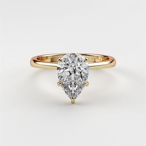Elegant 14K and 18K yellow gold engagement ring featuring a pear-shaped diamond, showcased on a model.