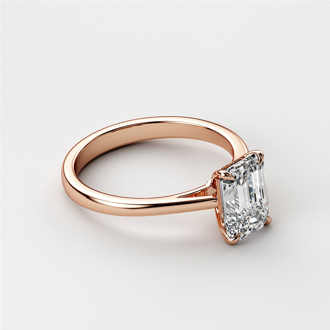 Elegant emerald-cut diamond engagement ring in 14K Rose Gold. A stunning solitaire for modern proposals and special moments.