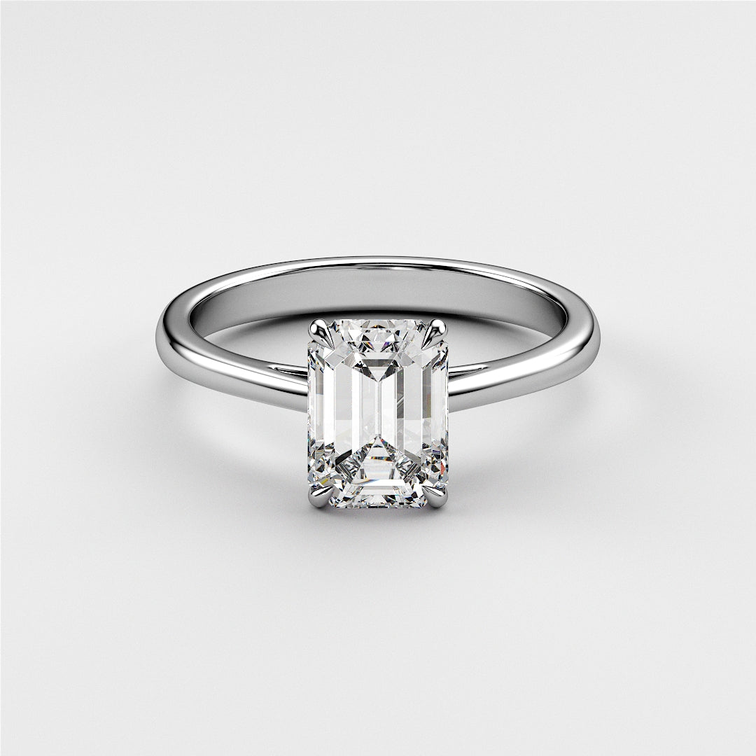 Stunning 14K or 18K white gold engagement ring featuring a radiant-cut emerald in a classic cathedral setting.