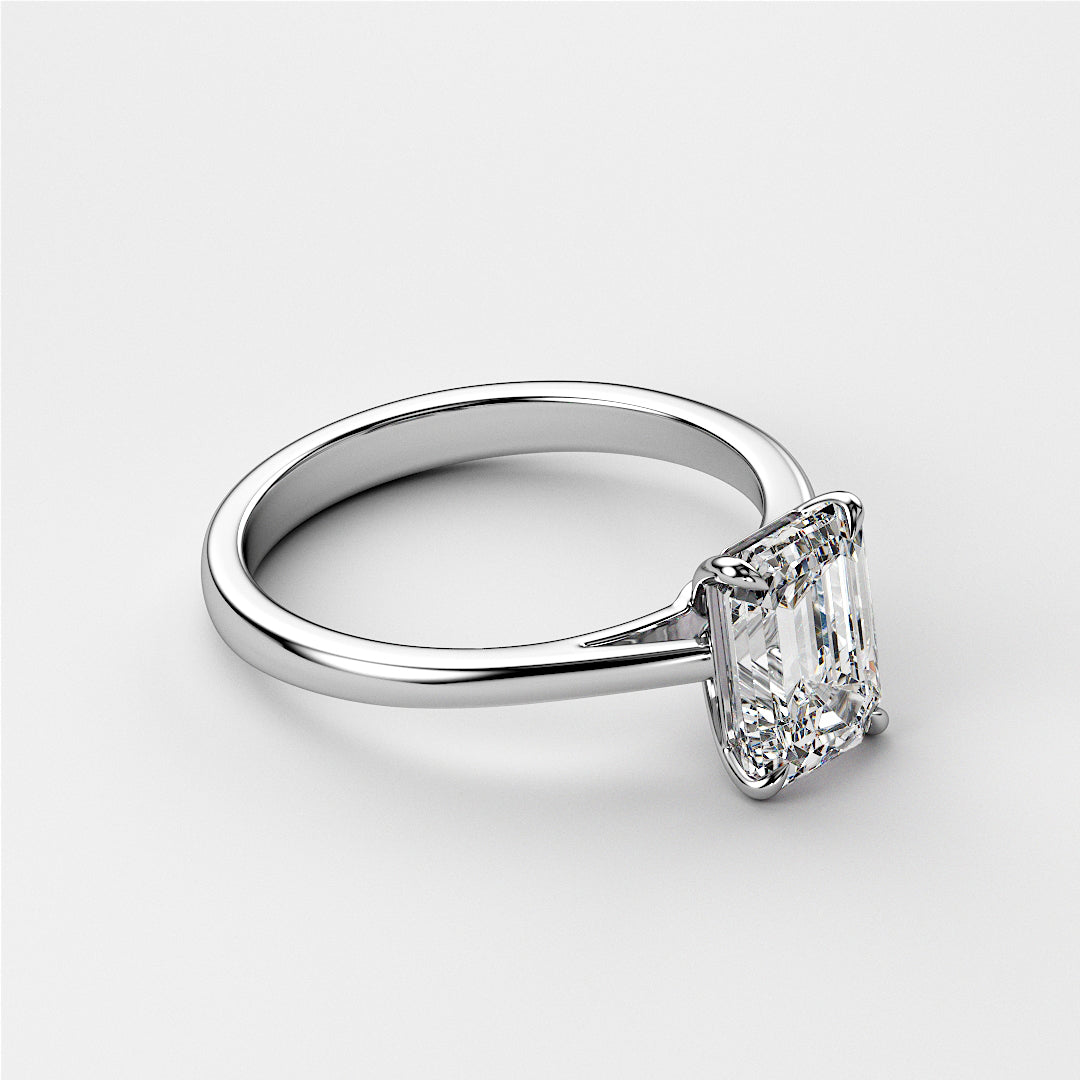 Elegant 14K or 18K white gold engagement ring featuring an emerald-cut diamond on a sophisticated cathedral band design.