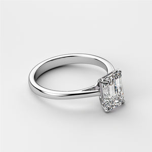 Elegant 14K or 18K white gold engagement ring featuring an emerald-cut diamond on a sophisticated cathedral band design.